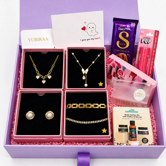Gift set with jewelry, chocolate, and other items in a purple box