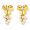 Gold floral earrings with pearl drops on a white background
