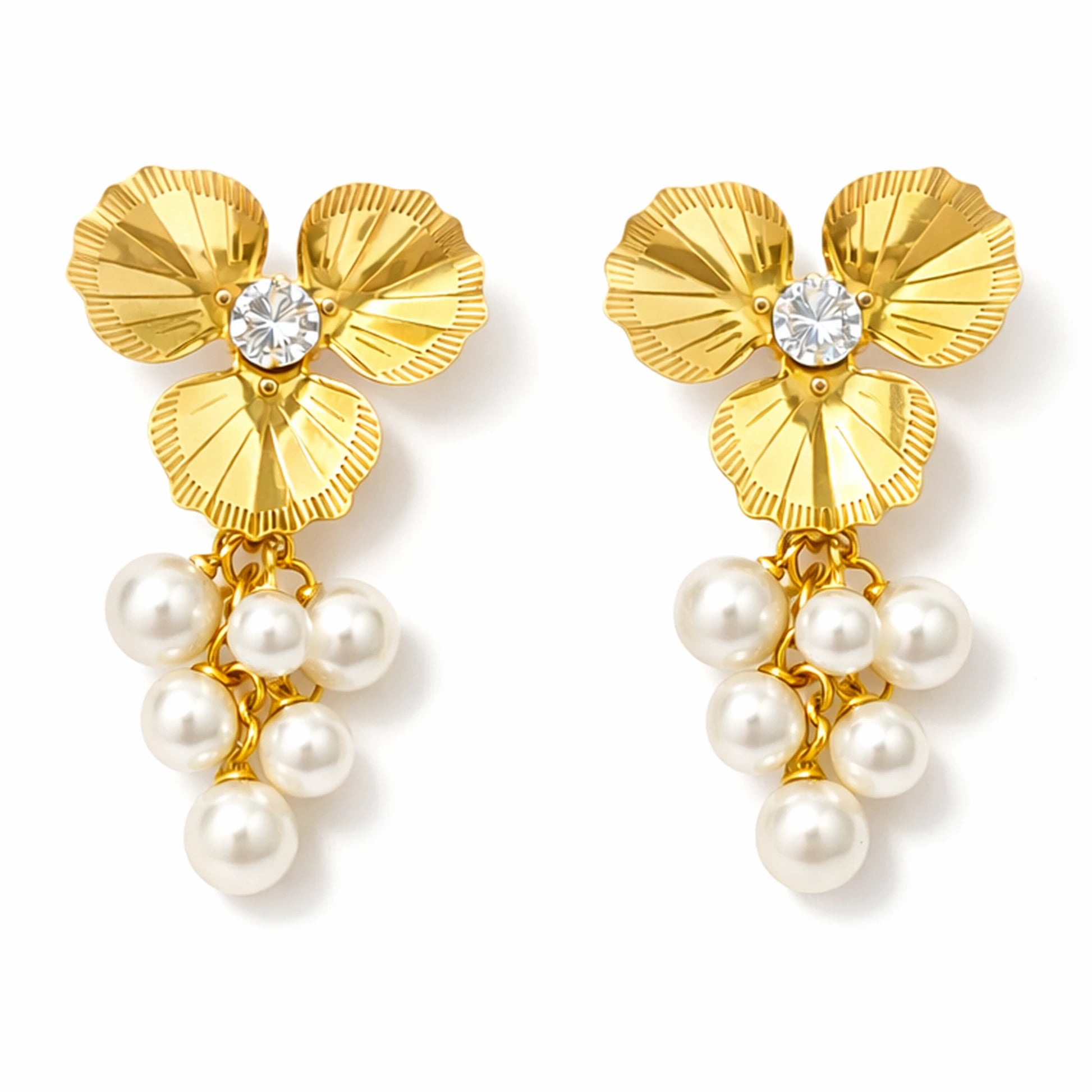 Gold floral earrings with pearl drops on a white background
