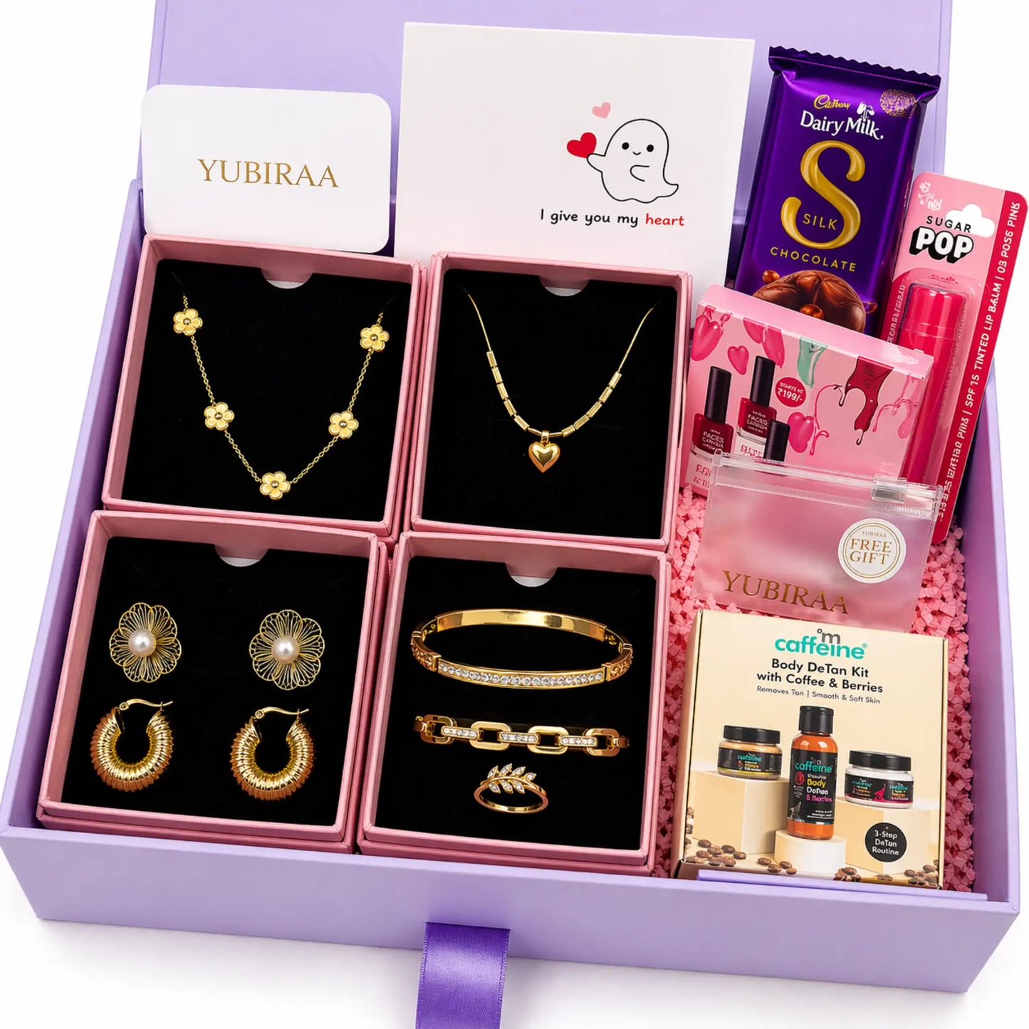 Gift set with jewelry, chocolate, and skincare products in a purple box.