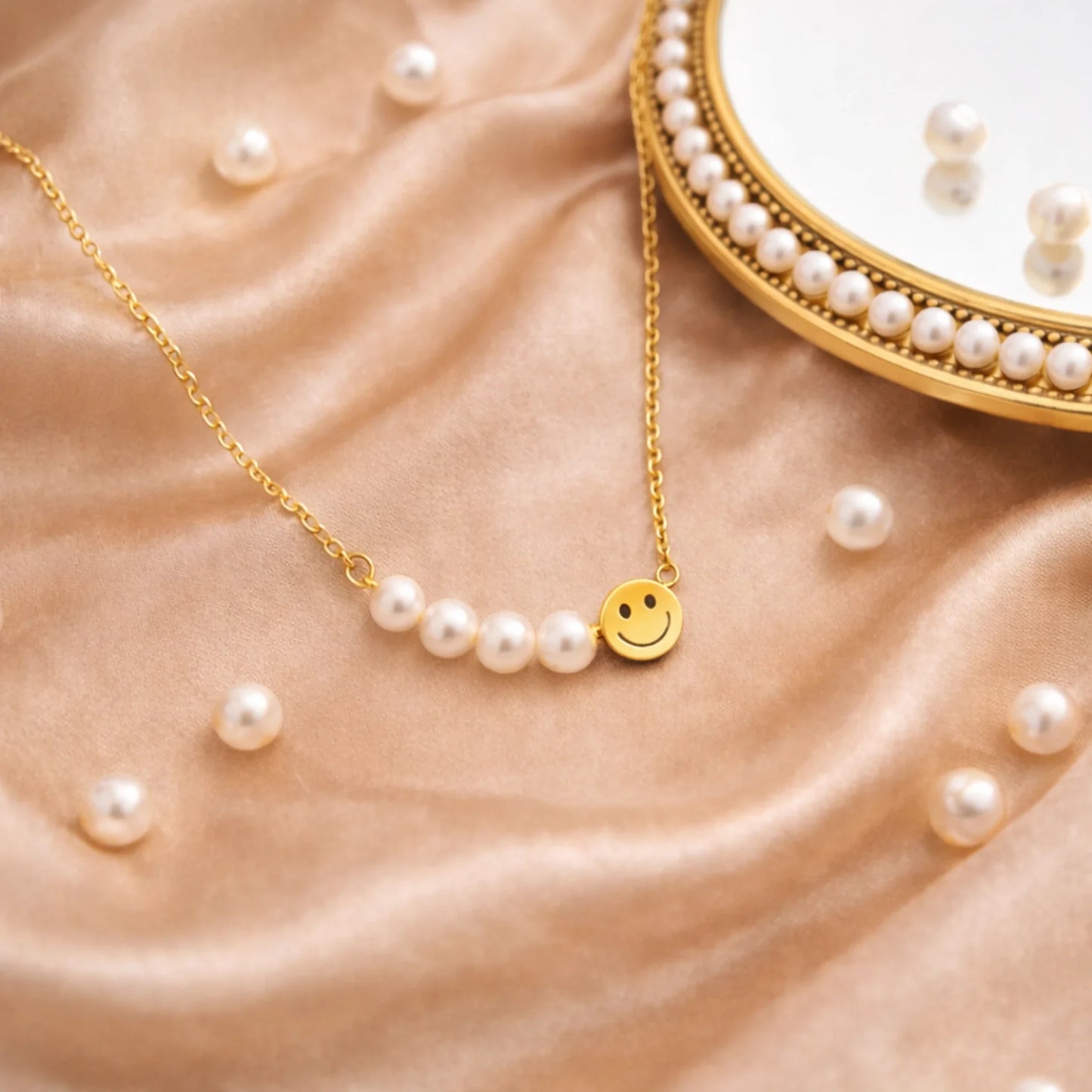 Pearl necklace with a smiley face charm on a beige fabric background