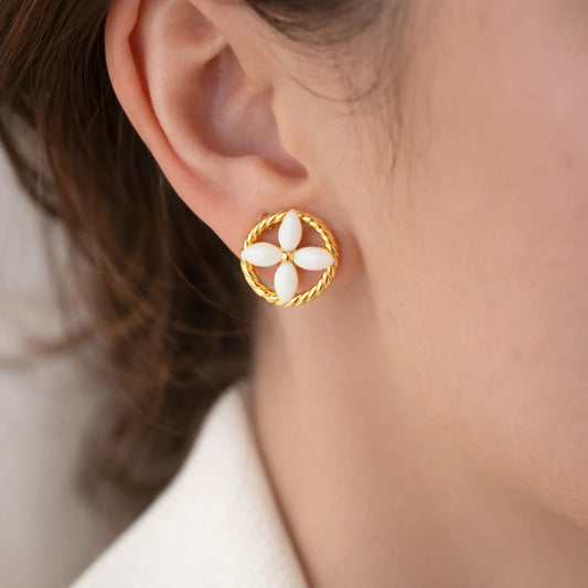 Gold plated floral stud earrings worn by model, anti tarnish lightweight everyday earrings with white enamel flower design