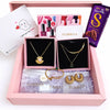 Jewelry set with necklaces, earrings, and a chocolate bar in a pink box labeled 'YUBIRAA'.