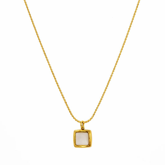 Gold necklace with a square pendant on a white background