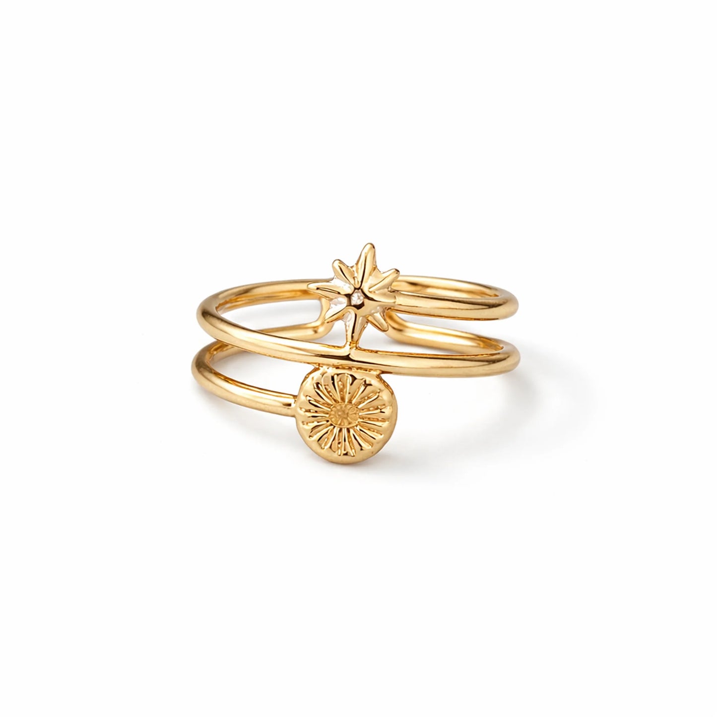 Gold ring with star and circle design on a white background