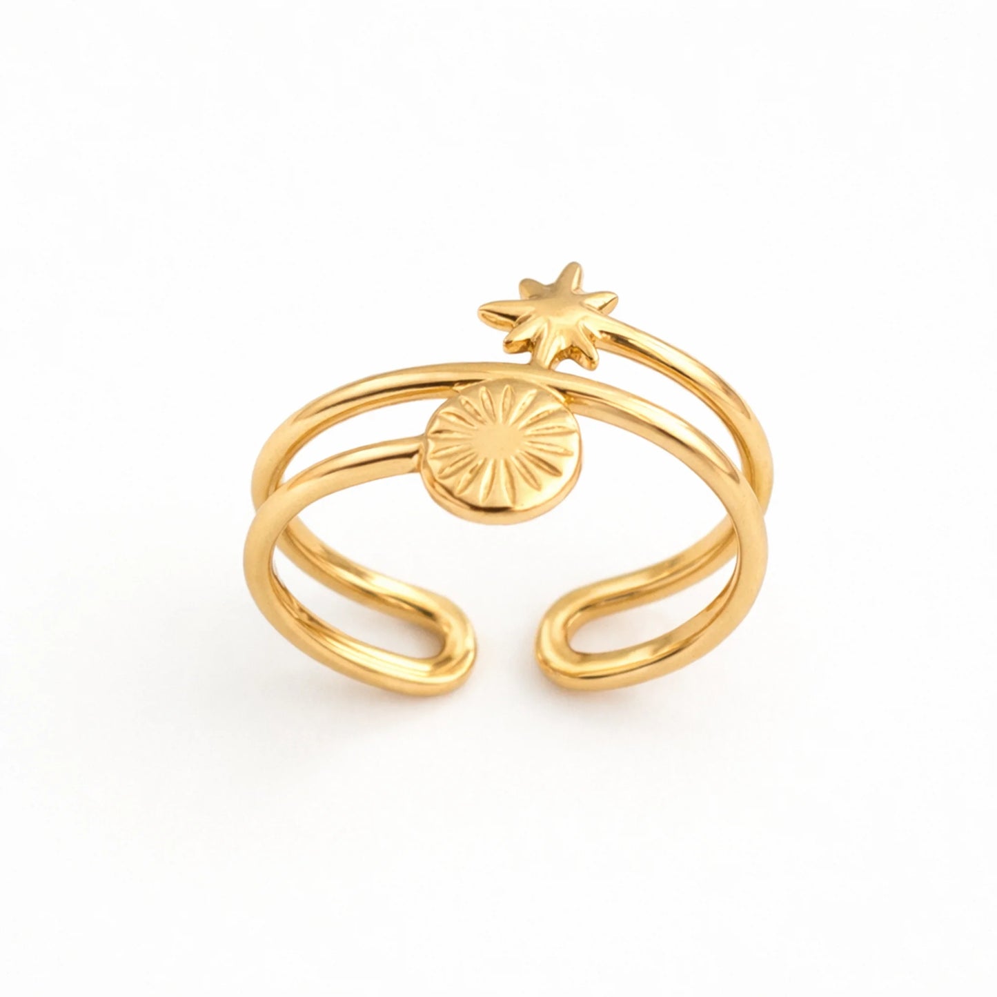 Gold ring with star and circular design on a white background