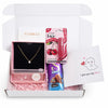 Gift box with jewelry, candy, and a card on a white background