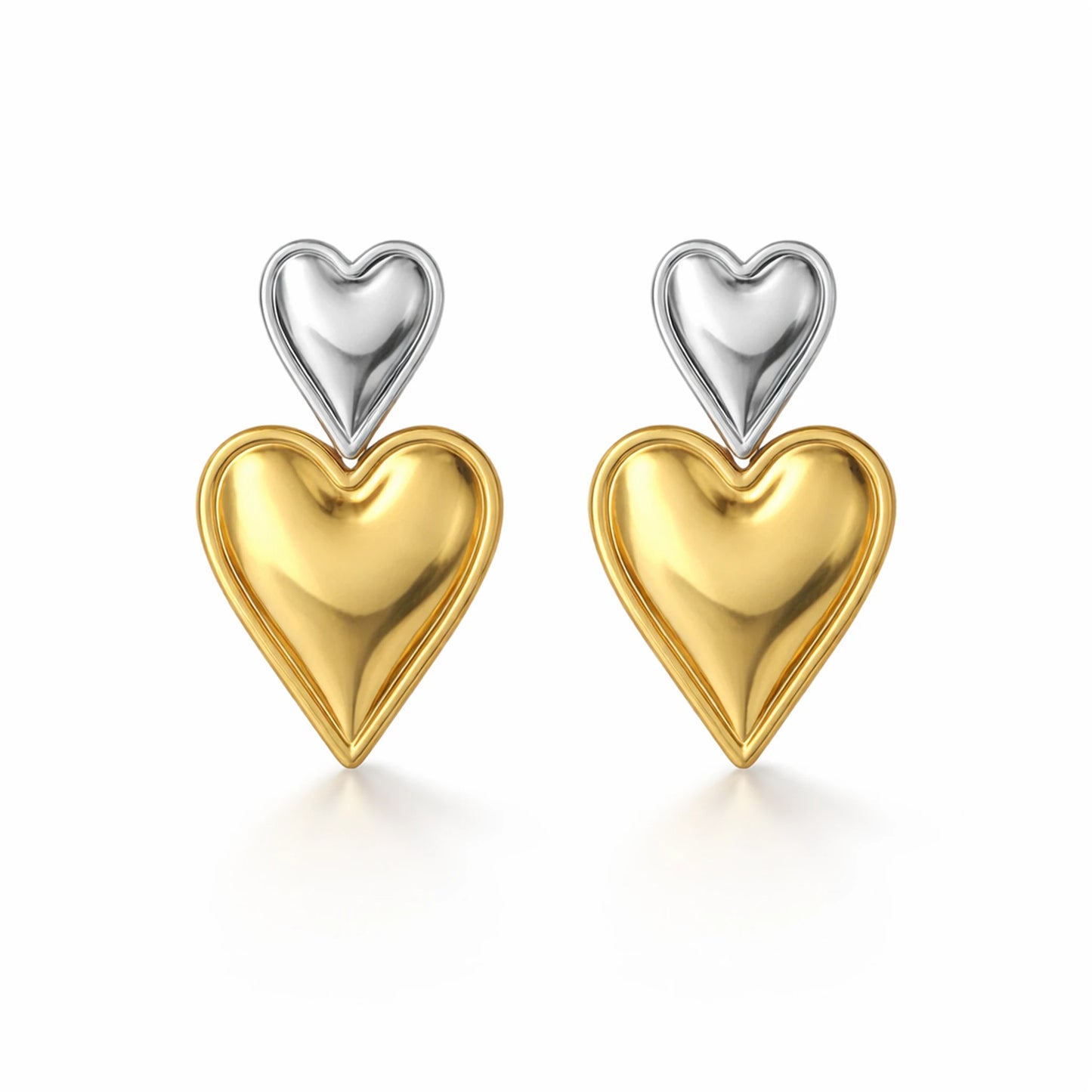 Heart-shaped earrings with gold and silver finish on a white background
