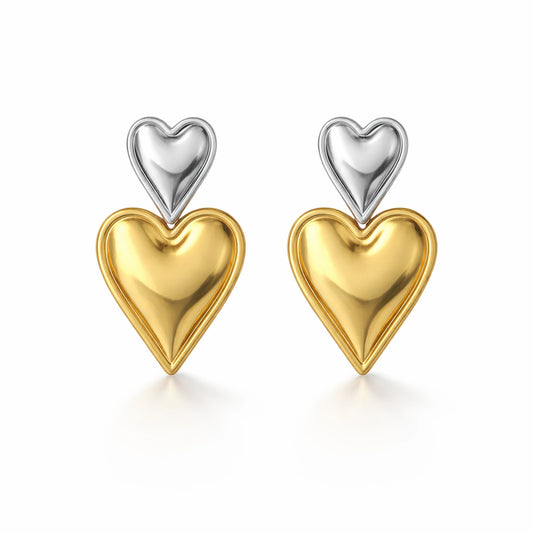 Heart-shaped earrings with gold and silver finish on a white background