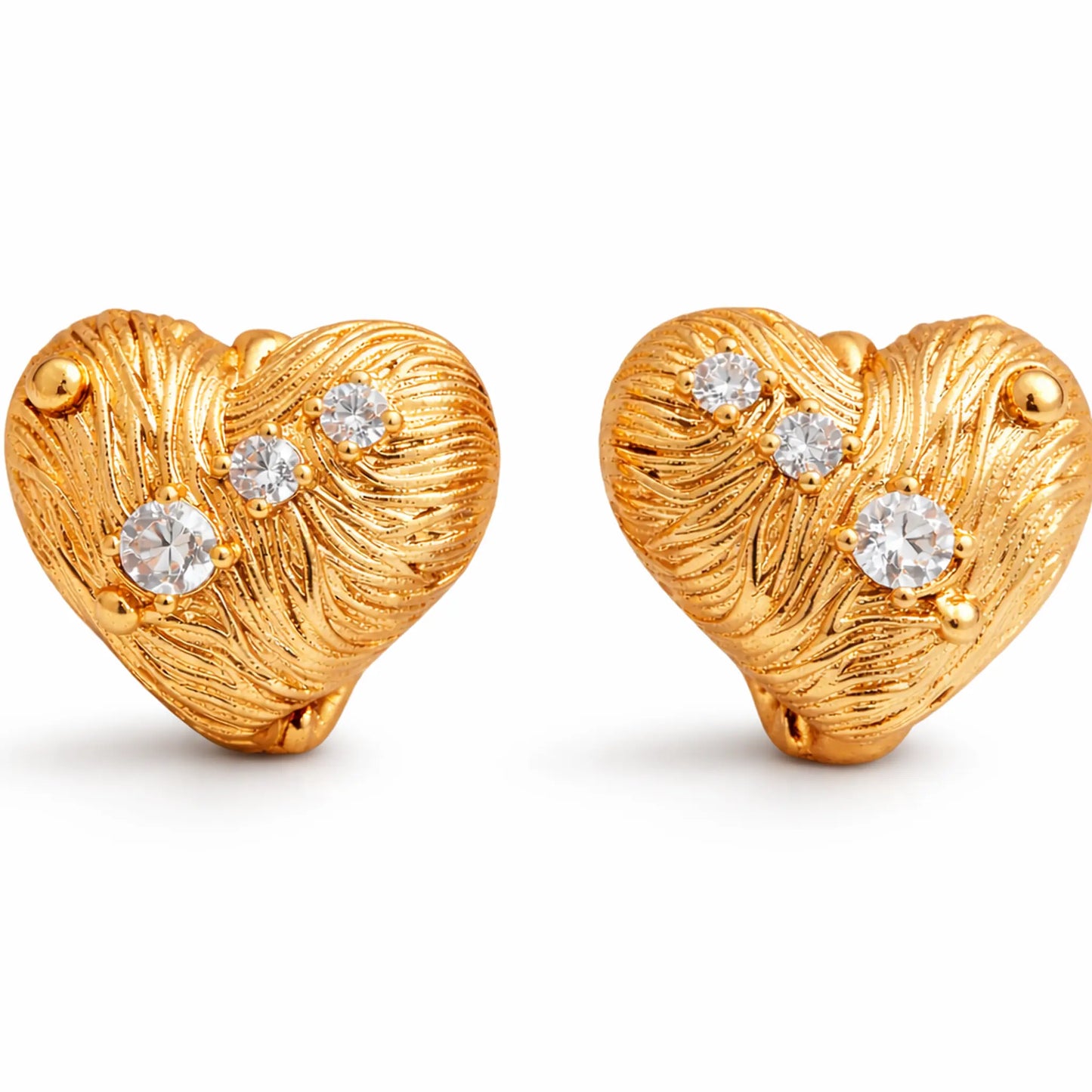 Anti-tarnish gold plated heart-shaped stud earrings with textured engraved finish and sparkling cubic zirconia stones on a white background