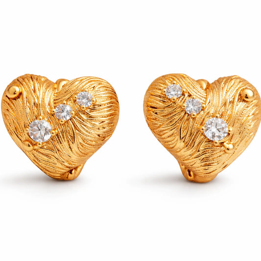 Anti-tarnish gold plated heart-shaped stud earrings with textured engraved finish and sparkling cubic zirconia stones on a white background
