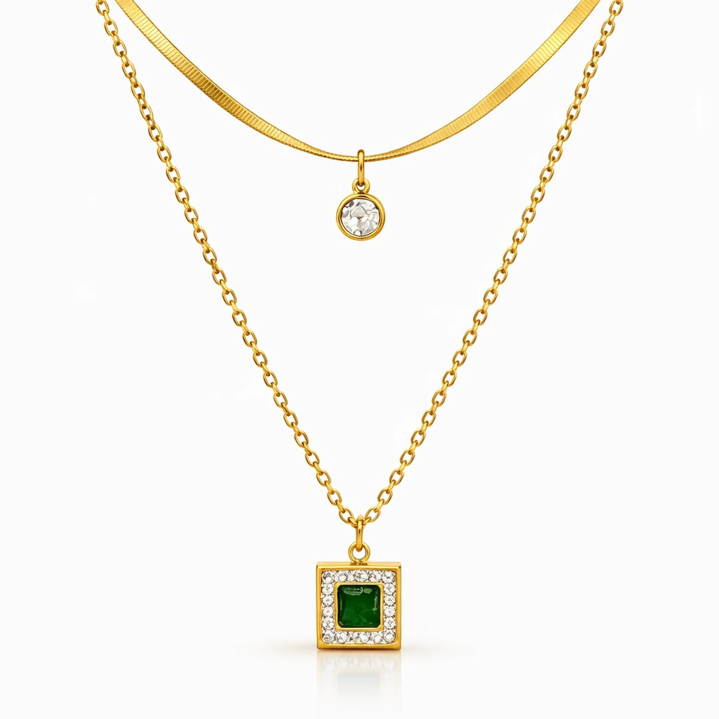 Layered gold tone necklace with emerald green square pendant and minimal round charm on upper chain