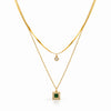 Double layer gold plated necklace with snake chain and sleek chain featuring green square stone pendant and crystal detailing