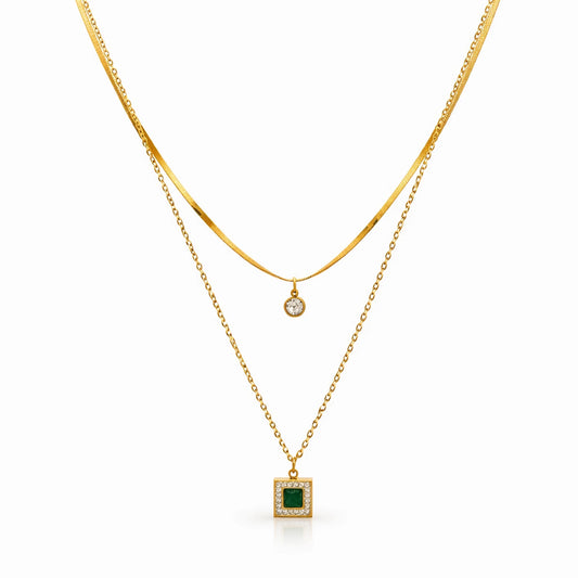 Double layer gold plated necklace with snake chain and sleek chain featuring green square stone pendant and crystal detailing