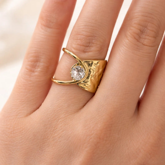 YUBIRAA adjustable gold solitaire ring worn on finger, showcasing modern statement design and crystal accent