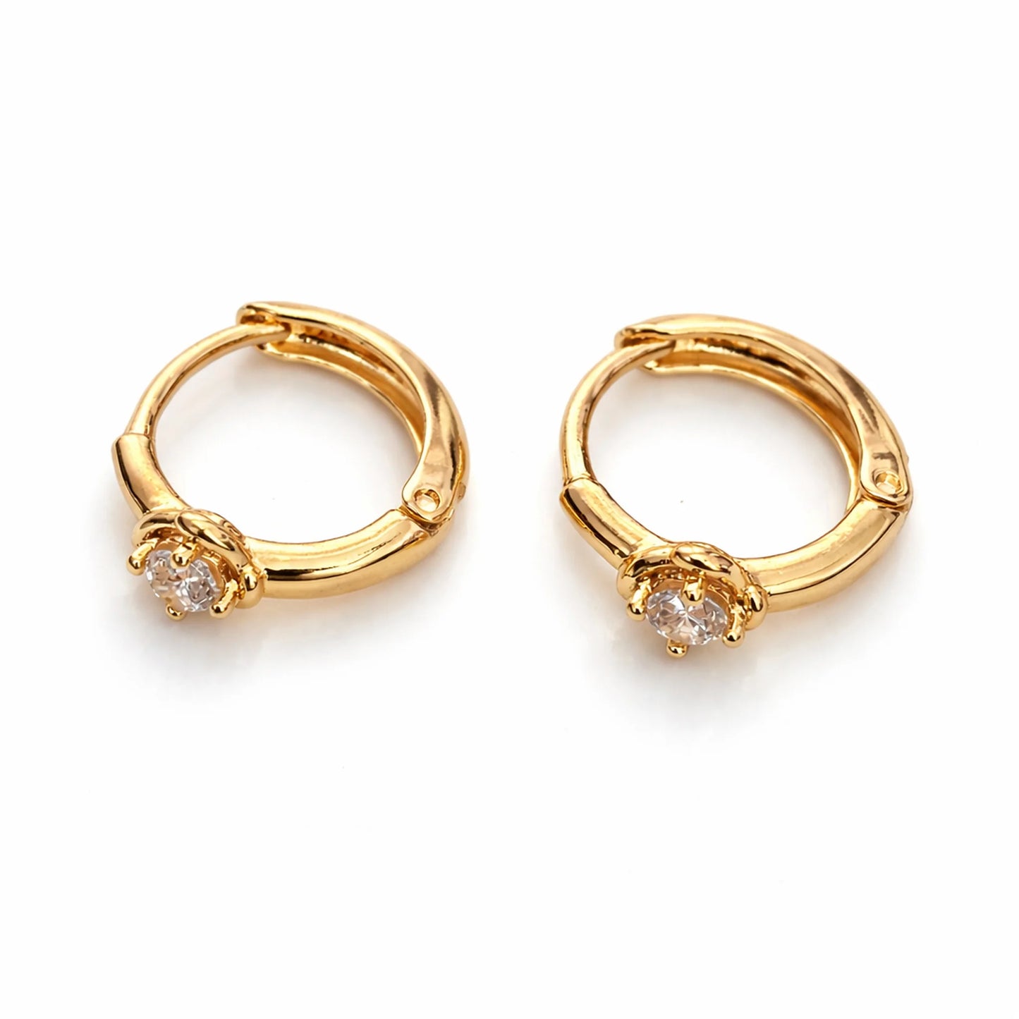 Gold hoop earrings with small diamonds on a white background