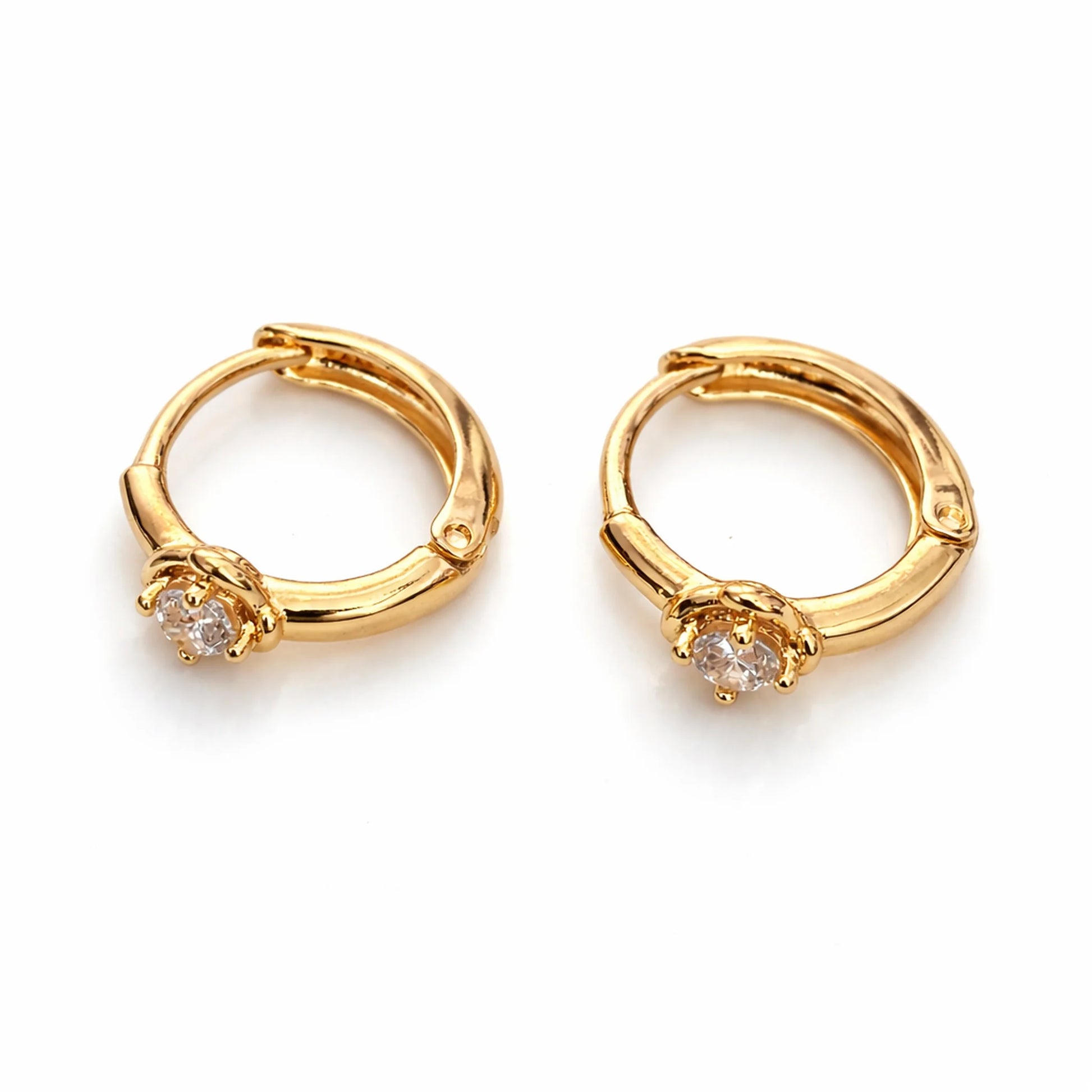 Gold hoop earrings with small diamonds on a white background