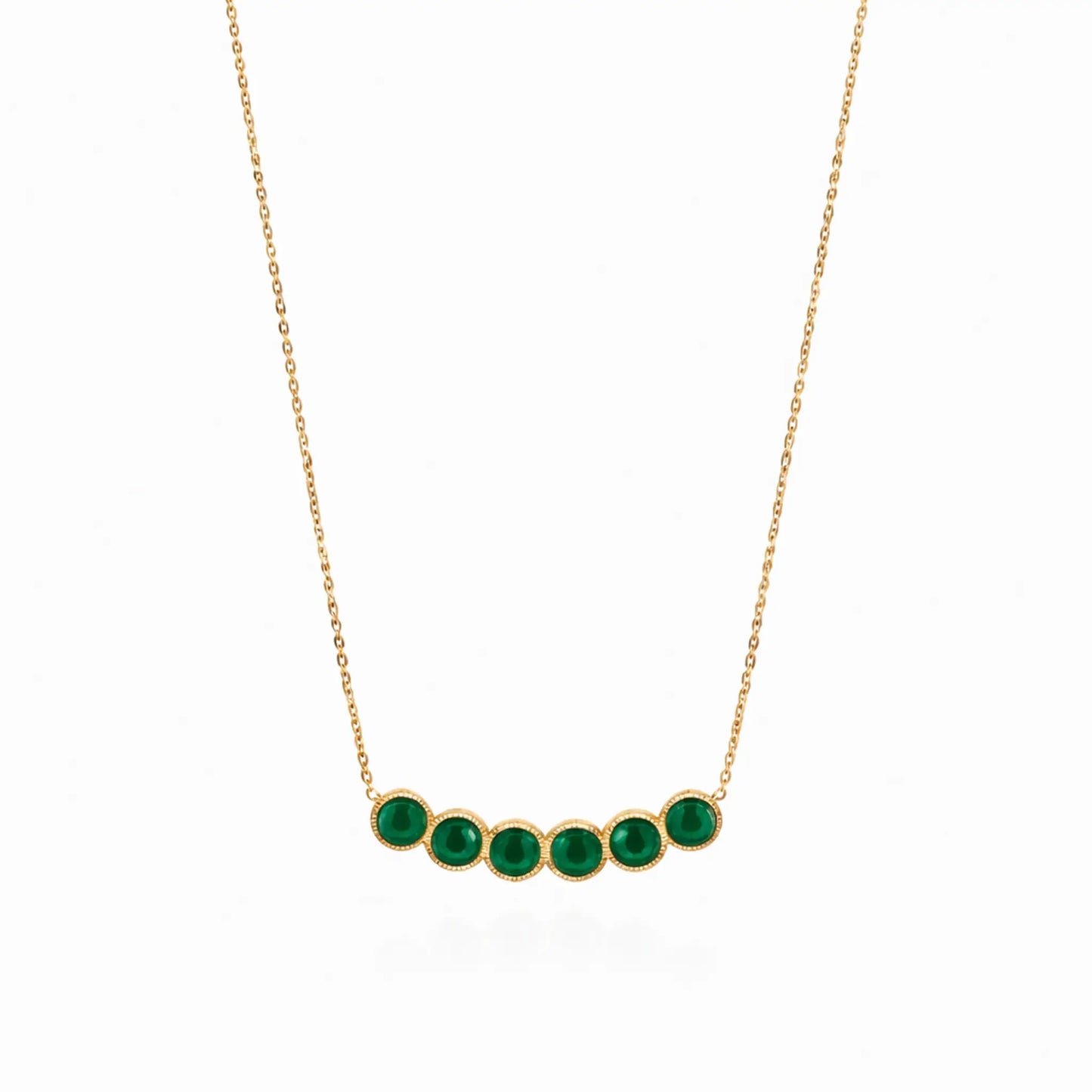 Gold necklace with green gemstones on a white background