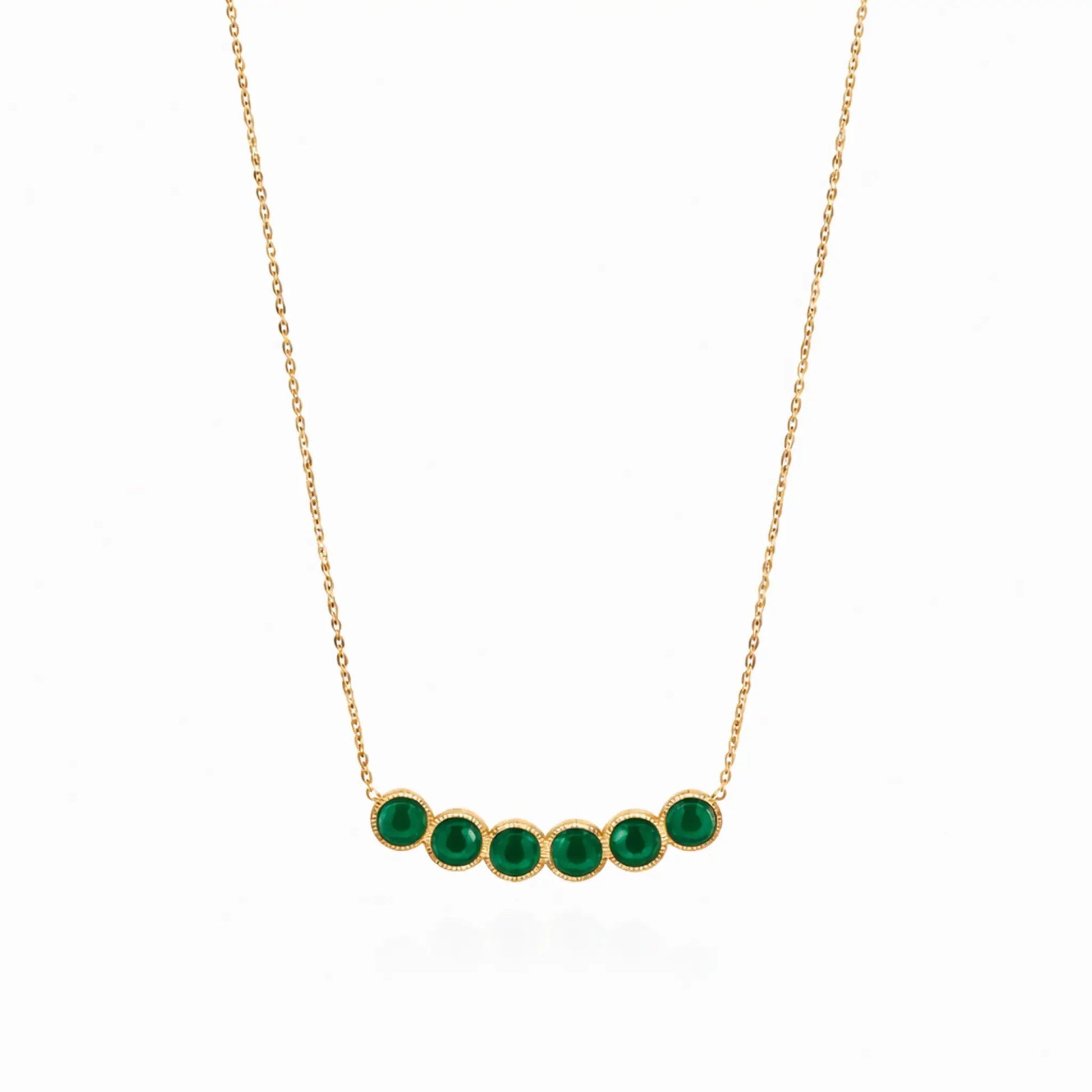 Gold necklace with green gemstones on a white background