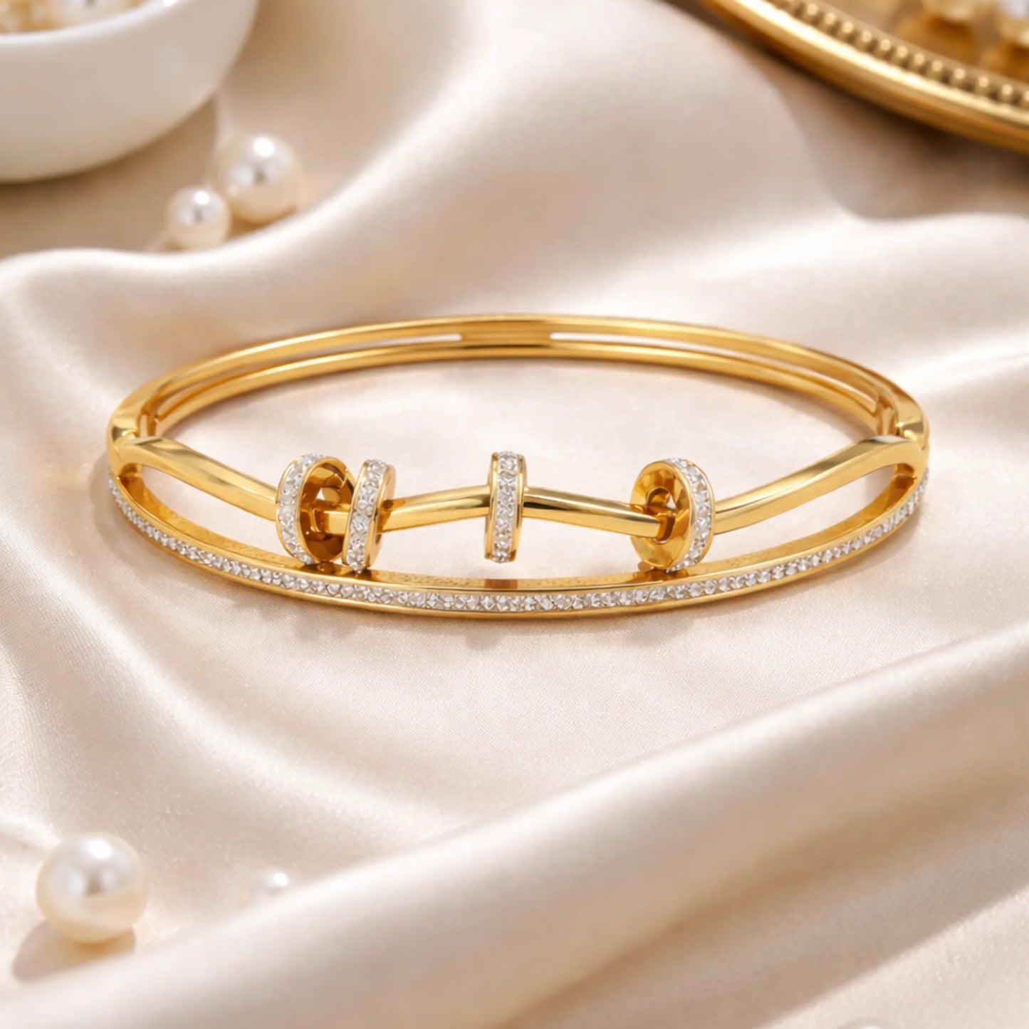 Gold bracelet with diamond accents on a soft, light-colored fabric background. YUBIRAA Dual Spark Loop Gold Bracelet styled for modern everyday and occasion wear
