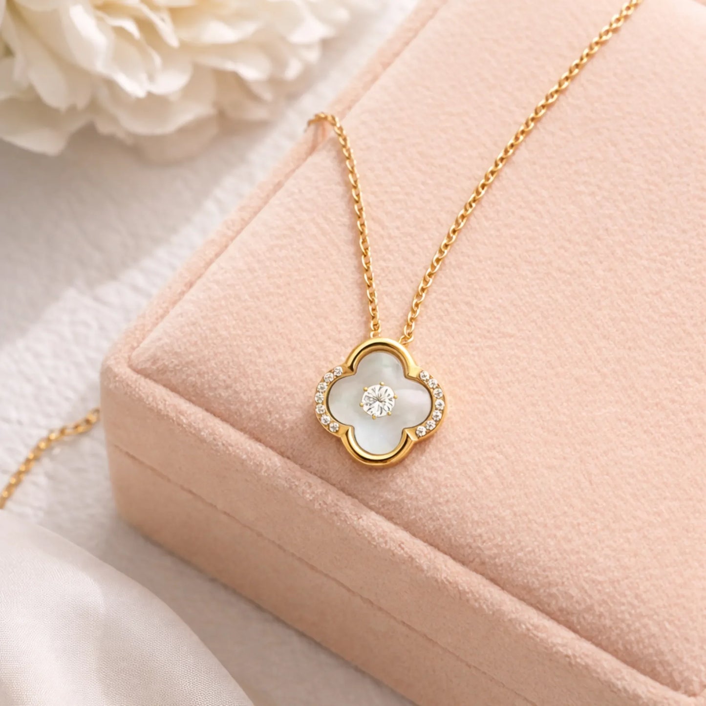 Lifestyle image of Ivory Glow Clover Necklace in anti tarnish gold plated stainless steel with mother of pearl clover pendant