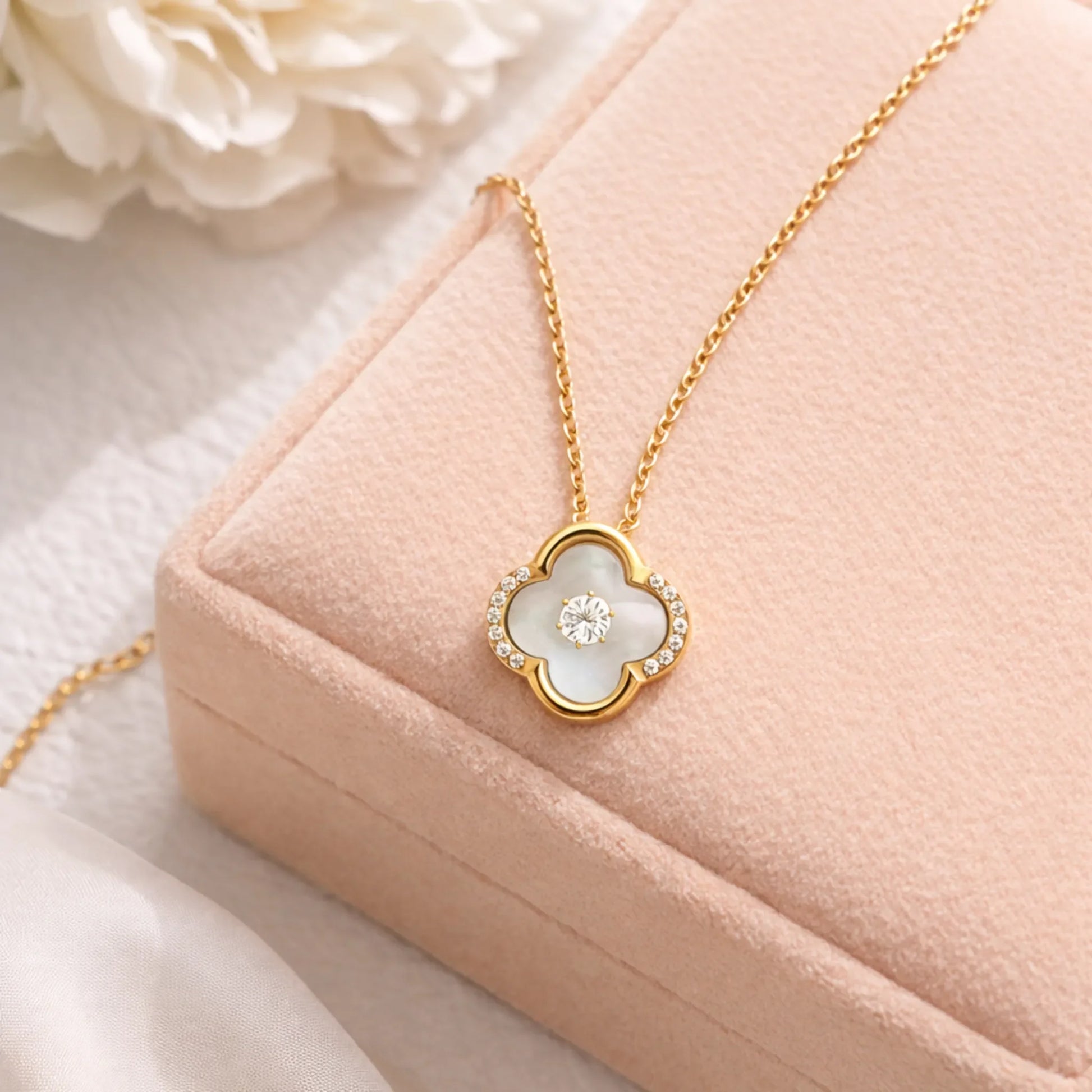 Lifestyle image of Ivory Glow Clover Necklace in anti tarnish gold plated stainless steel with mother of pearl clover pendant