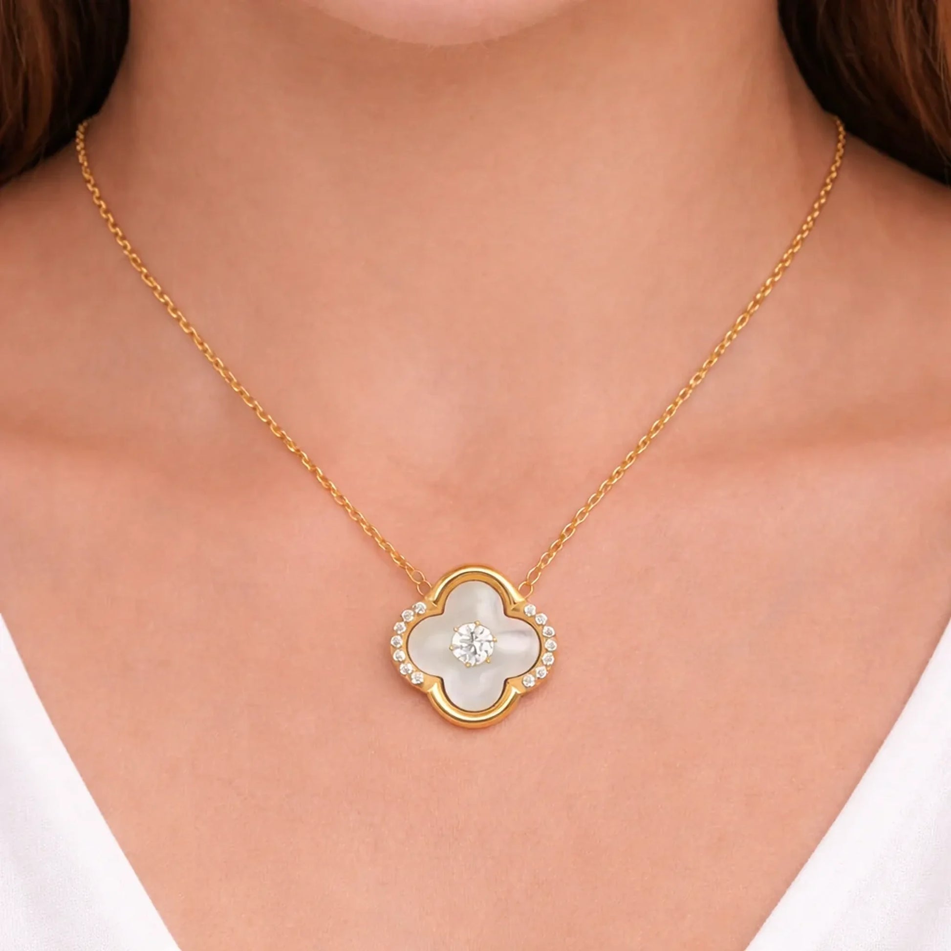 Model wearing Ivory Glow Clover Necklace in anti tarnish gold plated stainless steel with clover pendant