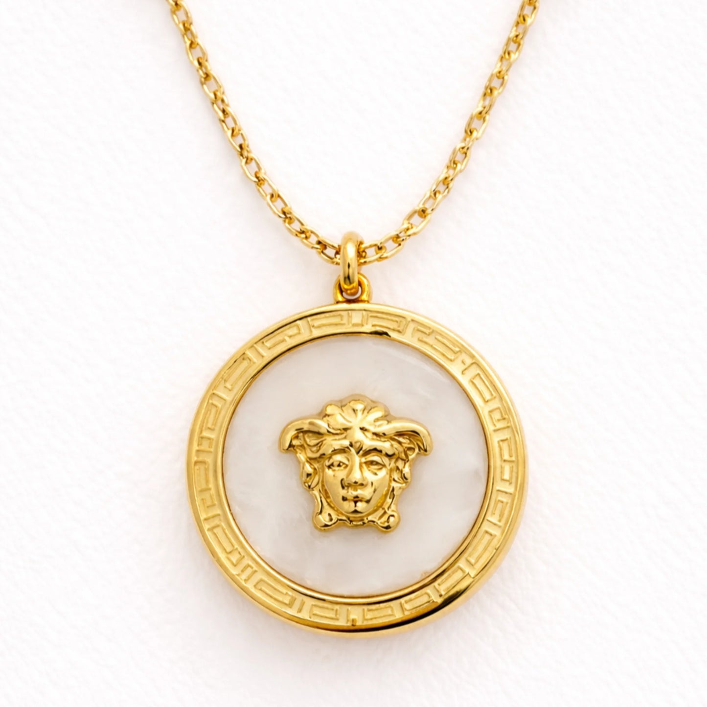 Close up of Yubiraa Final Ivory Glow Clover Necklace showing ivory stone clover pendant with polished gold plated finish”