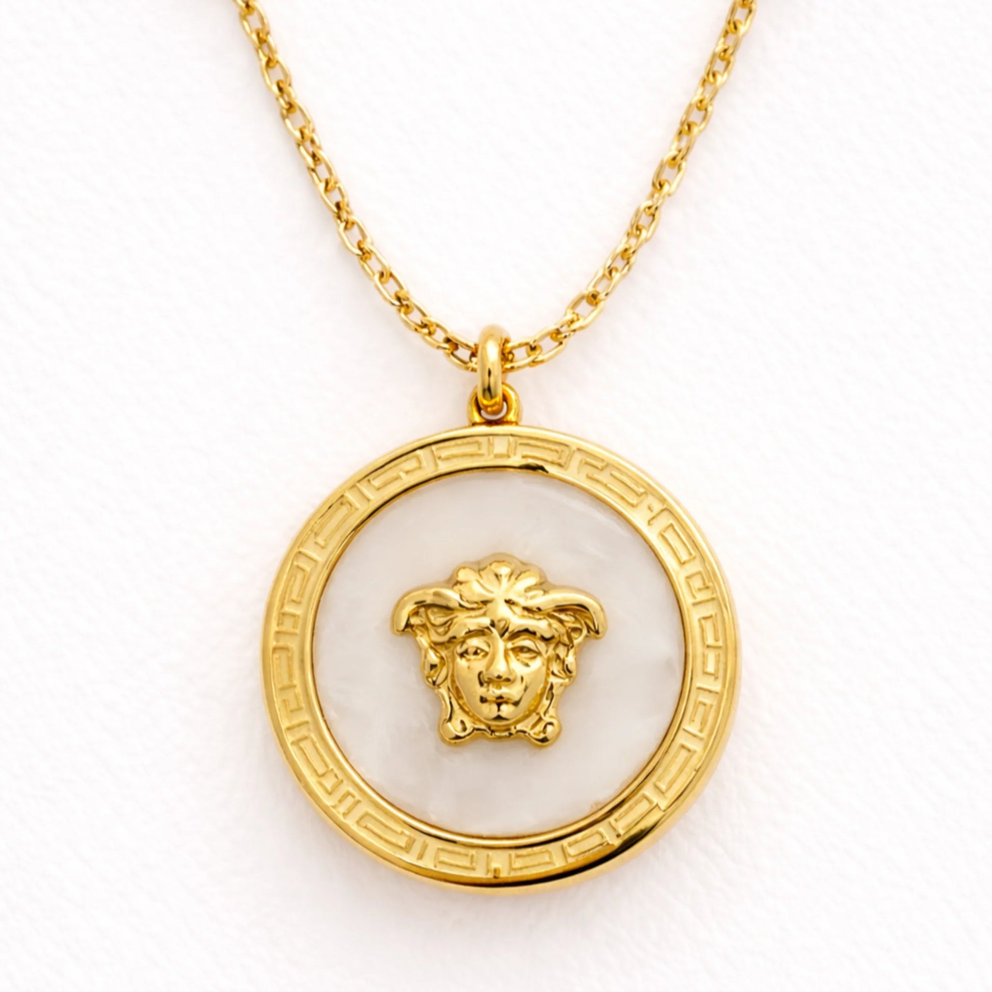 Close up of Yubiraa Final Ivory Glow Clover Necklace showing ivory stone clover pendant with polished gold plated finish”