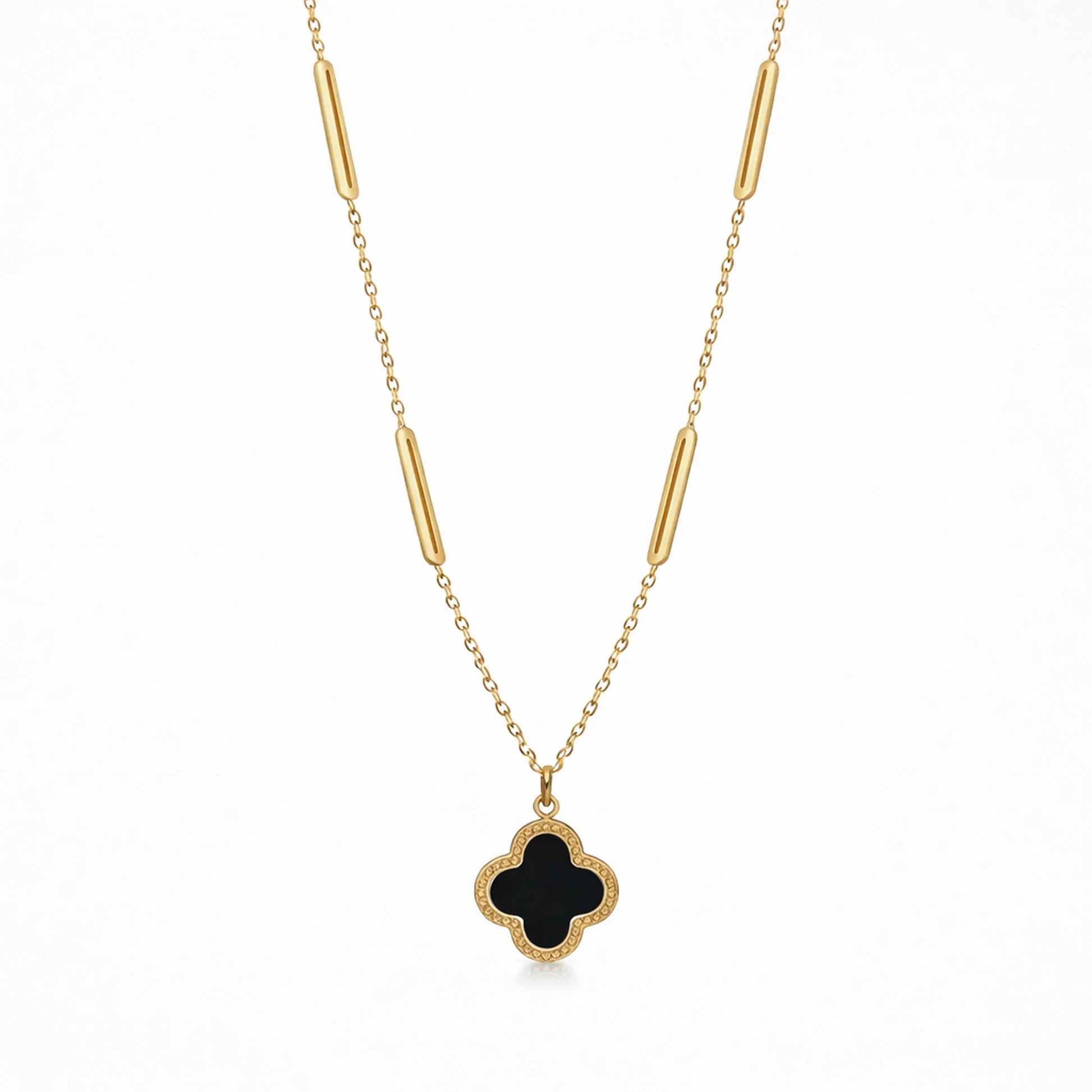 Full view of Yubiraa Final Ivory Glow Clover Necklace featuring black clover pendant and gold plated chain