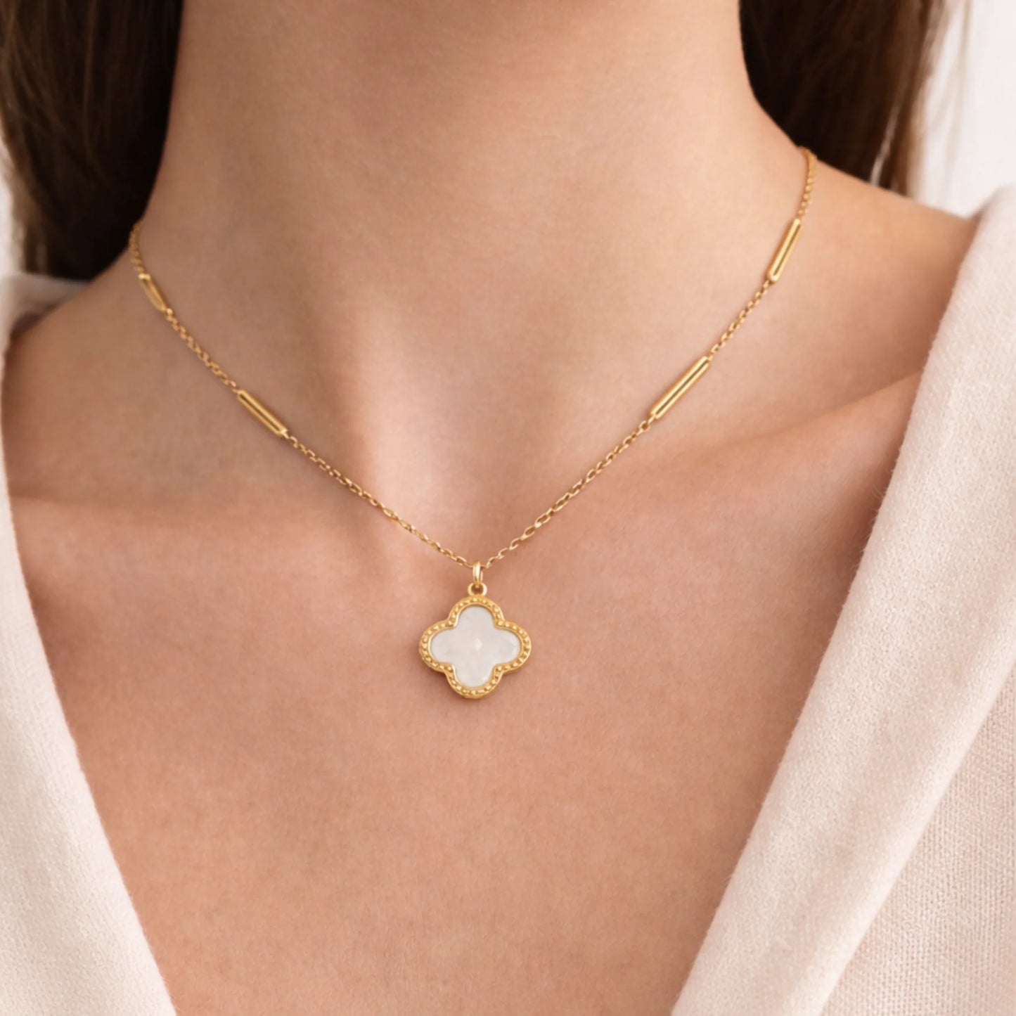 Model wearing Yubiraa Final Ivory Glow Clover Necklace with ivory clover pendant in gold plated stainless steel, neck only view