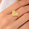 Model wearing gold textured heart adjustable ring on finger